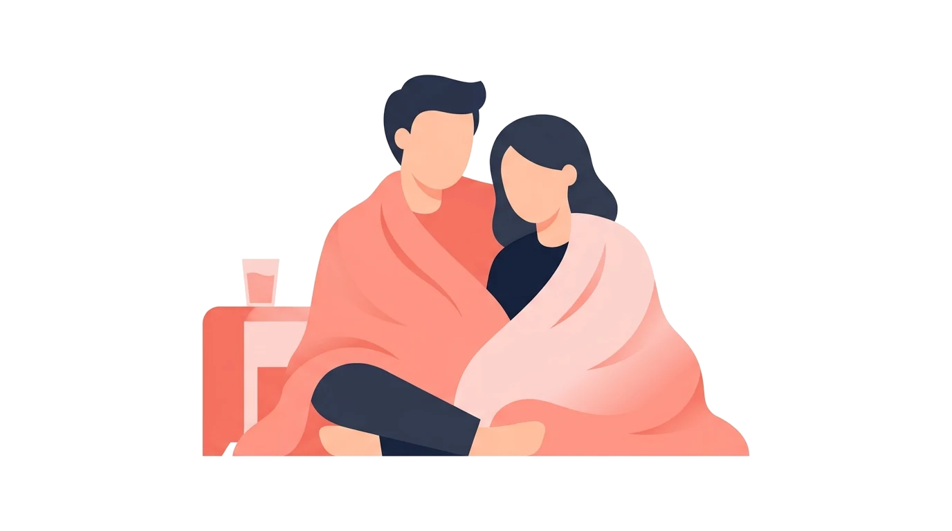 A couple wrapped together in a blanket resting close, illustrating aftercare and staying connected